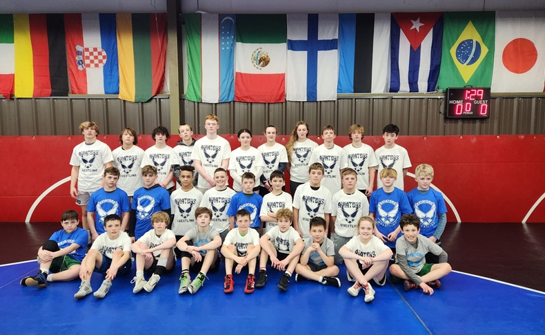 Aviators wrestlers gathered together on the Appleton mat